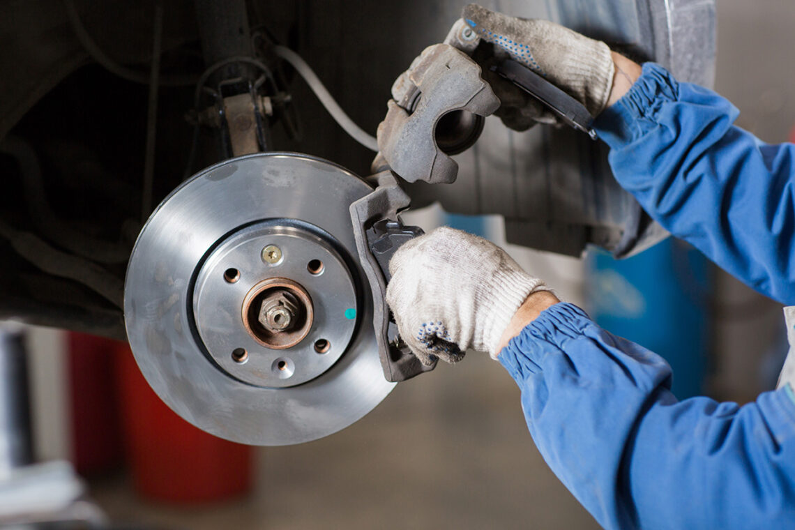 Technician working on brakes during a Jeep service appointment