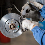 Technician working on brakes during a Jeep service appointment