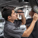 Jeep service technician inspecting tread depth